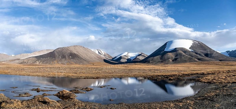 Glaciated mountain peaks reflected in a mountain lake, Kara-Say, Tian Shan, Issyk Kul Province, Kyrgyzstan, Asia
