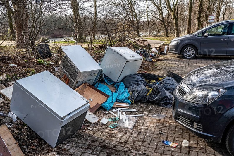 Illegal waste disposal in a car park, in a wooded area, tyres, furniture, refrigerators, household waste, oil cans, Oberhausen North Rhine-Westphalia, Germany, Europe