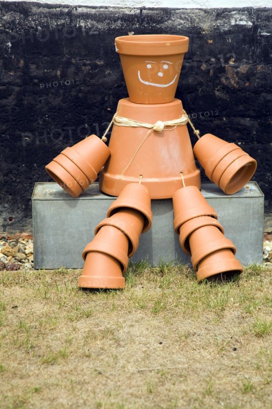 Flowerpot man sitting on metal tub, England, UK