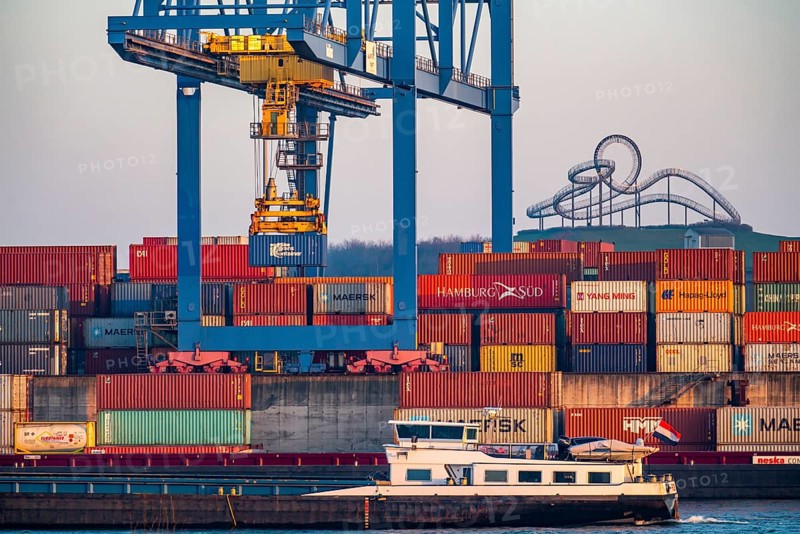 Container Handling Centre, Gateway West Terminal, Logport 2, cargo ship, in Duisburg on the Rhine, in the background Tiger and Turtle - Magic Mountain is a landmark modelled on a roller coaster on Heinrich-Hildebrand-Höhe in Angerpark in Duisburg-Angerhausen, North Rhine-Westphalia, Germany, Europe