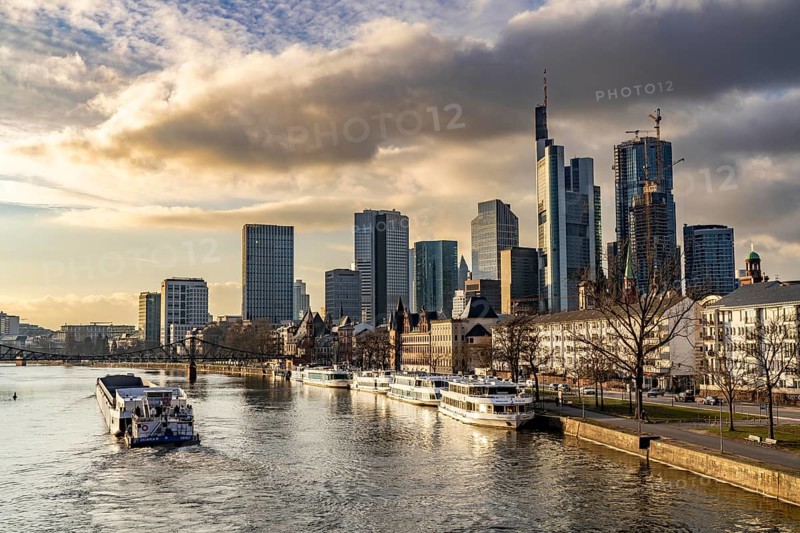 Skyline of the city centre of Frankfurt am Main, river Main, excursion boats at the Main quay, freighter, dusk, Hesse, Germany, Europe