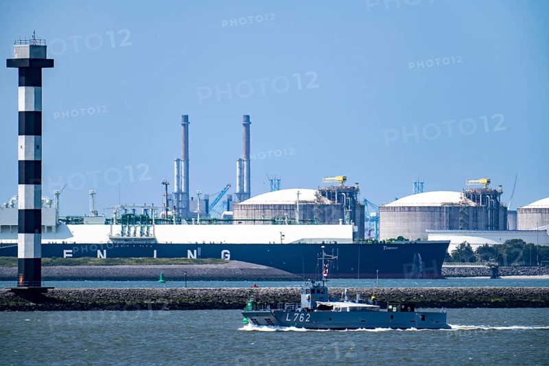 LNG import terminal tanks for liquefied natural gas in the seaport of Rotterdam, freighter, the Greek-flagged LNG liquefied gas tanker Tenergy during unloading, German naval landing craft L762, salmon, Maasvlakte, Rotterdam Netherlands