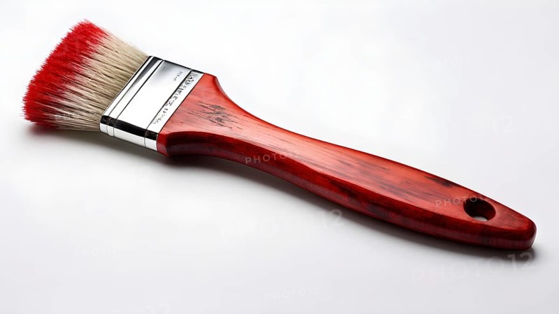 Thick paintbrush dipped in red bristles dripping onto a white background, AI generated