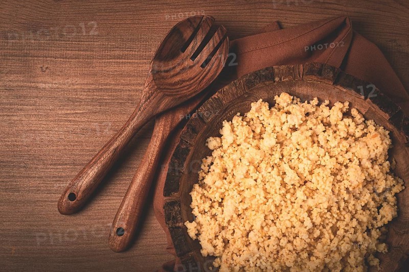 Cooked couscous, in a wooden bowl, top view, no people