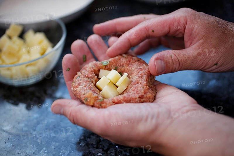 Swabian cuisine, preparation of meatballs in an almond shell, mixed minced meat, raw, meatballs filled with cheese, meatballs, grandmother's cooking, regional, home cooking, typical Swabian, traditional cuisine reinterpreted, men's hands, food photography, studio, Germany, Europe