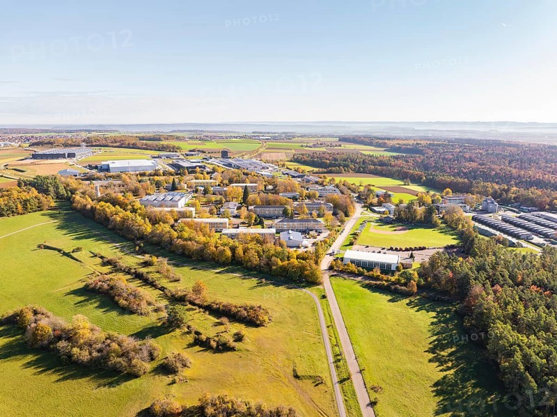 Industrial area next to fields and autumnal forest, seen from above, high ropes course, Nagold, Black Forest, Germany, Europe
