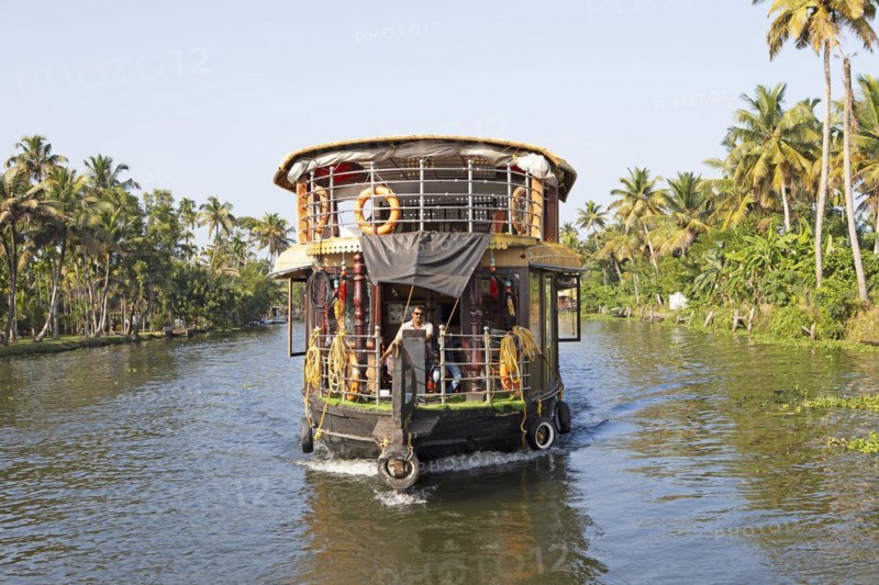 Traditional houseboat on a canal in the canal system of the backwaters, Kerala, India, Asia