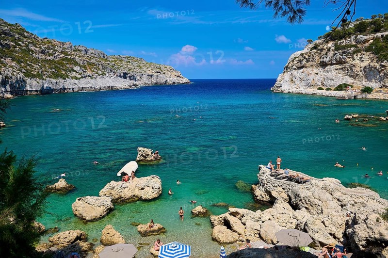 An idyllic bay with crystal-clear water, surrounded by rocks under a bright blue sky, Anthony Quinn Bay, Vagies Bay, Rhodes, Dodecanese, Greek Islands, Greece, Europe