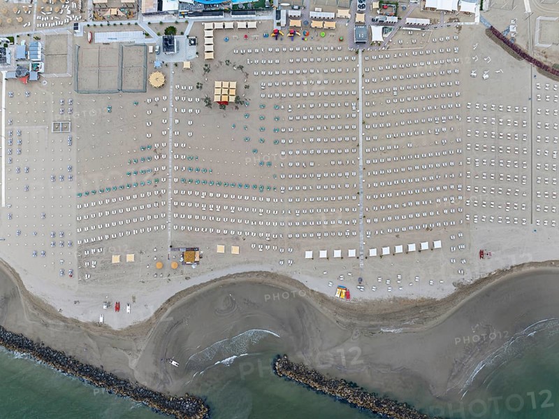 Bathing beach in Rimini. Bathing beach on the Adriatic in bad weather. All deckchairs are free. Drone photo. Rimini, Province of Rimini, Italy, Europe