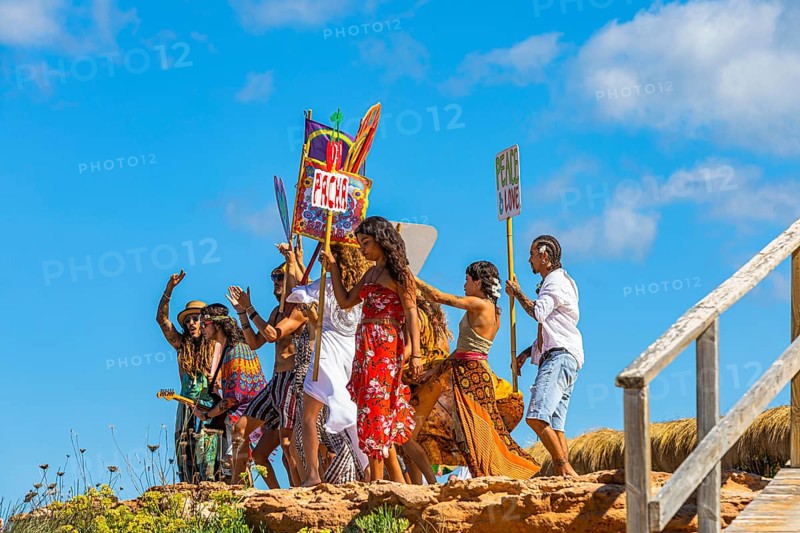 Colourfully dressed youths with musical instruments and banners form a love parade and promote the nightclub Pacha, Cala Comte, Ibiza, Balearic Islands, Mediterranean Sea, Spain, Europe