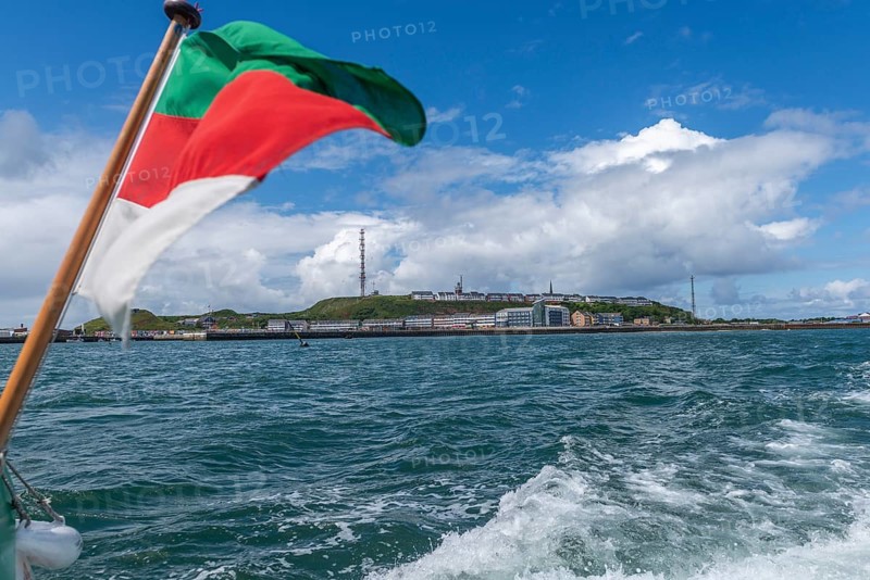 View from south-east to harbour facilities, Unterland and Oberland, offshore island Heligoland, Heligoland flag, radio tower, blue sky, North Sea, Pinneberg district, Schleswig-Holstein, Germany, Europe