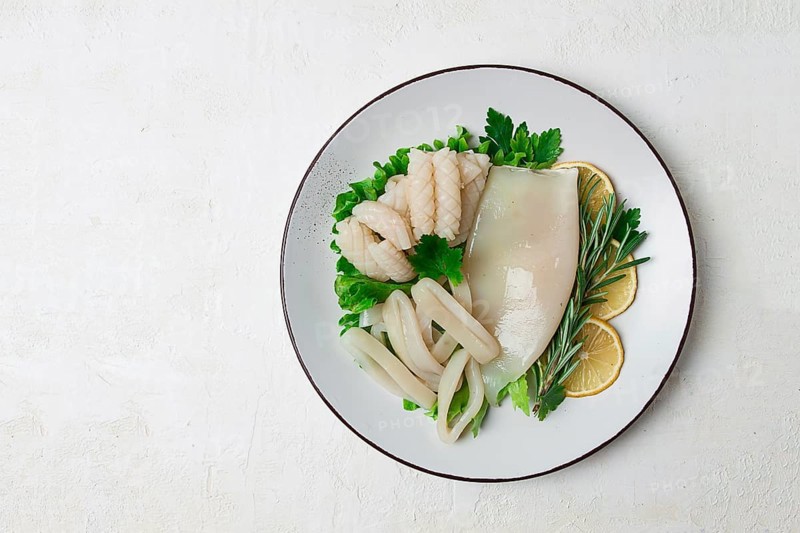 Fresh squid, raw, carcass, cut into rings, top view, no people