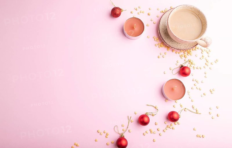 Christmas or New Year composition. Decorations, red balls, cup of coffee, on a pink paper background. Top view, copy space, flat lay