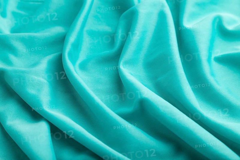 Fragment of silk blue tissue. Side view, natural textile background and texture. wave concept, abstract