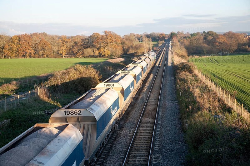 Open waggons of freight train on the West Coast mainline at Woodborough, Wiltshire, England, UK