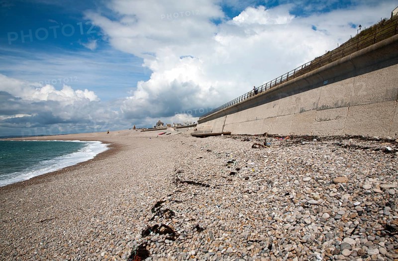 Shingle beach and large sea wall providing coastal defence at Chiswell, Isle of Portland, Dorset, England, UK