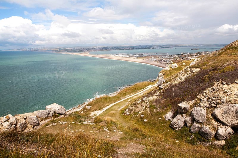 Chiswell village at the start of Chesil Beach with Weymouth harbour beyond, Isle of Portland, Dorset, England, United Kingdom, Europe