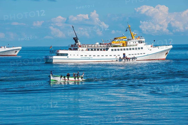 White ferry 'Fair Lady' during embarkation off the island of Heligoland, boats with people on open sea under blue sky, calm water, Börteboote, Schleswig-Holstein, Germany, Europe