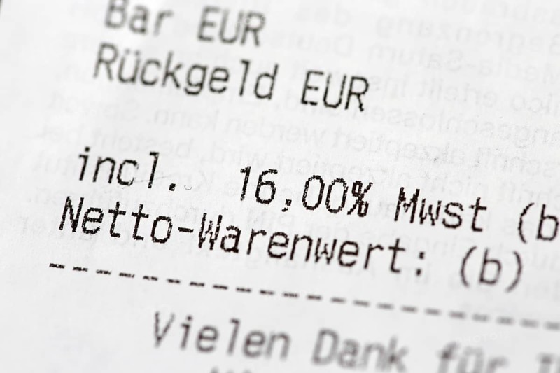 Close-up of a till receipt showing the reduction in VAT to sixteen per cent in Germany due to the coronavirus crisis