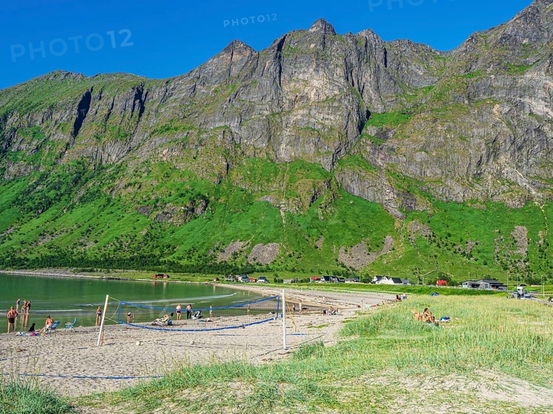 Beach Ersfjordstranden, fjord Ersfjord, public recreation area, beach volleyball, view to mountain range Okshornan, island Senja, Troms, northern Norway, Norway, Europe