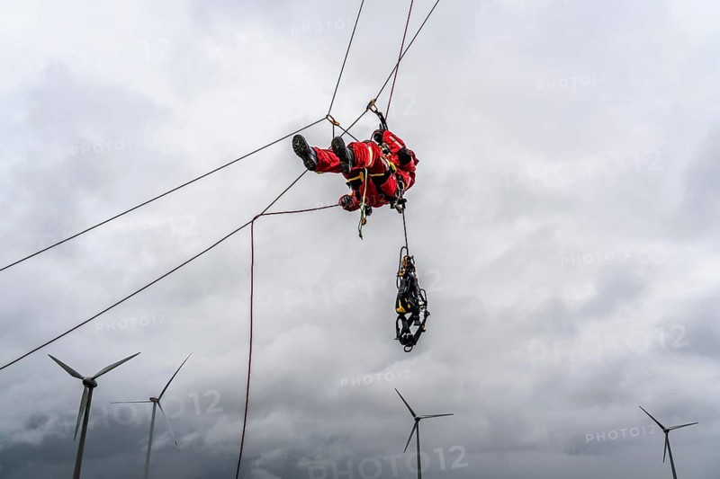 Height rescuers from the Oberhausen fire brigade practise abseiling from a wind turbine from a height of 150 metres after rescuing an accident victim from the nacelle, Issum, North Rhine-Westphalia, Germany, Europe