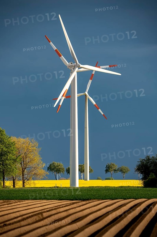 Wind turbines on a rape field, dark rain clouds, in the Rhenish lignite mining area, near Erkelenz-Holzweiler