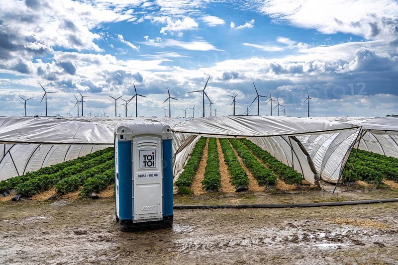 Agriculture, large areas with foil tunnel, for the cultivation of strawberries, wind farm, south of Lövenich, belongs to Erkelenz, in the district of Heinsberg, mobile loo for field workers, North Rhine-Westphalia, Germany, Europe