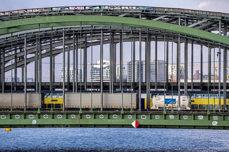 Railway Elbe bridges, at Elbbrücken station, spanning the Norderelbe, goods train, regional train, in the background the skyline of Hamburg, Germany, Europe