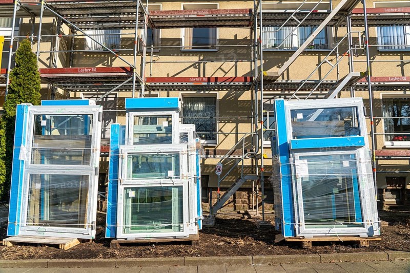 Energy-efficient refurbishment of residential buildings, older apartment block is scaffolded, gets thermal insulation and new windows, Germany, Europe