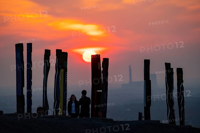 The Haniel spoil tip, 185 metre high spoil tip, at the Prosper Haniel mine, which was closed in 2019, artwork Totems by the sculptor Augustin Ibarrola, sunset, Bottrop, Germany, Europe