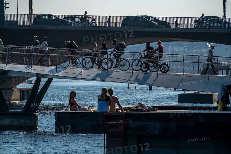 Cyclists on the Lille Langebro cycle and pedestrian bridge, behind it the Langebro road bridge, over the harbour, Copenhagen is considered the cycling capital of the world, 45% of the population travel by bike, Denmark, Europe