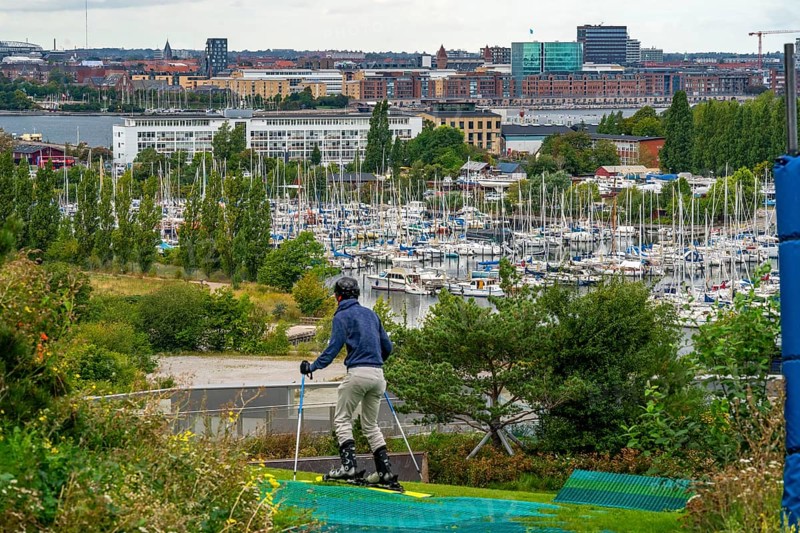 CopenHill, waste incineration plant and artificial ski slope, skiing with a view of Margretheholms Havn marina, ski lift, 90 metres high and 400 metre long slope on artificial turf, Copenhagen, Denmark, Europe