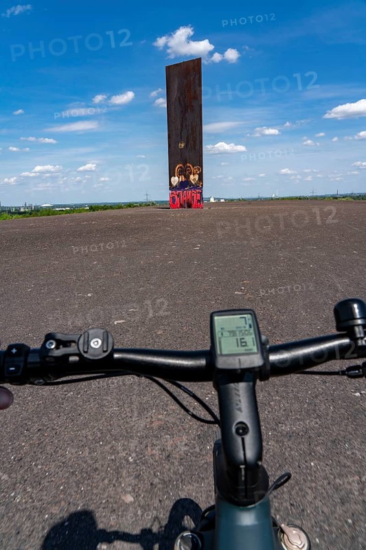 Cycling in the Ruhr area, on the Schurenbach slag heap, Bramme landmark for the Ruhr area by artist Richard Serra, Essen, North Rhine-Westphalia, Germany, Europe