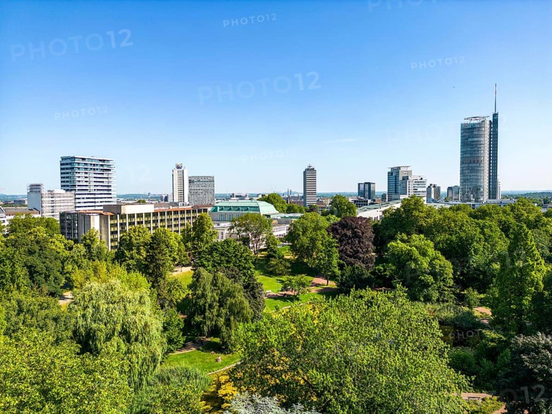The skyline of Essen city centre, with the RWE Tower on the right and Stadtgarten Park in front, North Rhine-Westphalia, Germany, Europe