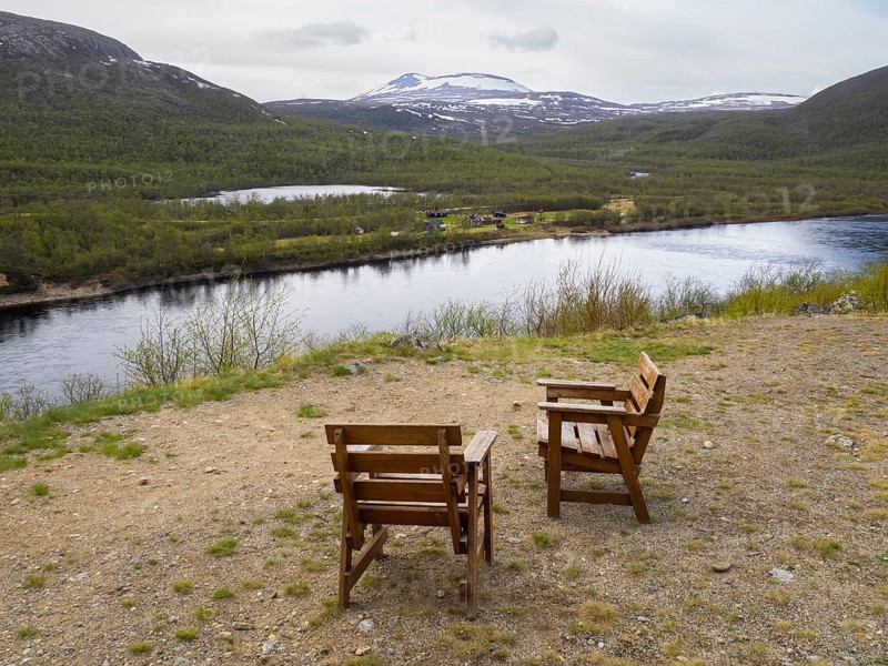 Seats provided for tourist at a vantage point on side of the 895 road, to admire the view across the Tana or Tanaelva River, which forms the border between Northern Finnish Lapland and Norway, May, Finnmark