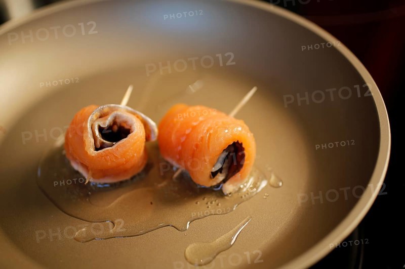 Southern German cuisine, preparation of sorrel soup with char, frying raw char fillets in a pan, oil, freshwater fish, savoury, salty, traditional cuisine, food photography, studio, Germany, Europe