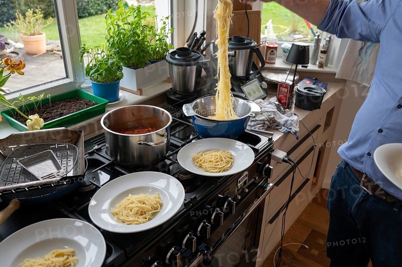 Lunch of a family, freshly cooked spaghetti is distributed on plates for the family, Bavaria, Germany, Europe