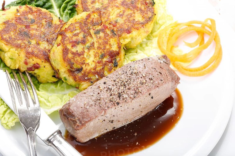 Swabian cuisine, medallions of wild boar with savoy cabbage cakes, meat dish, roasted, hearty, home cooking, typical Swabian, arranged on a plate, traditional cuisine reinterpreted, food photography, studio, Germany, Europe