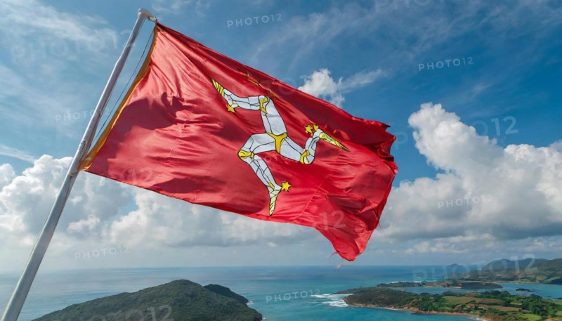 The flag of the Isle of Man, Great Britain, flutters in the wind