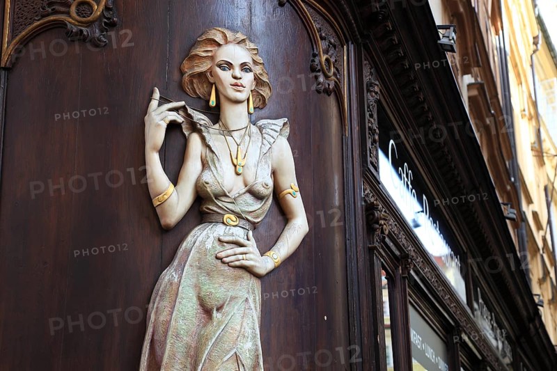 Scantily clad young woman as a facade decoration on a shop in Karlsgasse, Old Town, Prague, Czech Republic, Europe