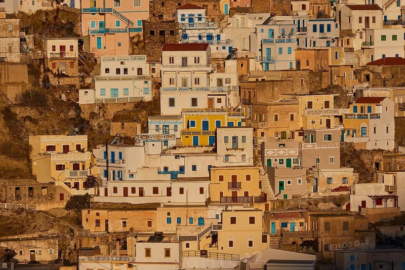 Densely built houses in bright colours on a sunny slope, Colourful mountain village, Morning light, Olymbos, Karpathos, Dodecanese, Greek Islands, Greece, Europe