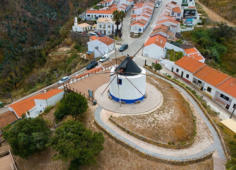 Aerial view of a village with a central windmill surrounded by houses with orange-coloured roofs, Odexeice, Faro, Algarve, Portugal, Europe
