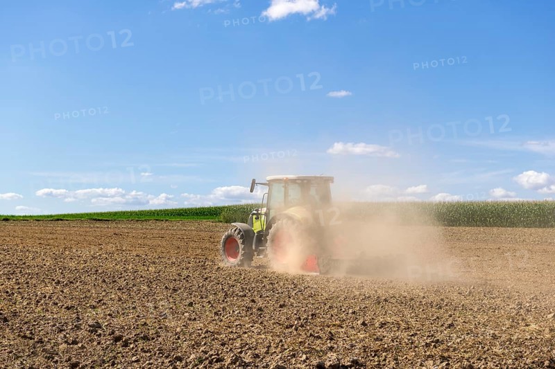 Symbolic image, global warming, dry soil, dust, farmer tilling a field, tractor, ploughing, clouds, Baden-Württemberg, Germany, Europe