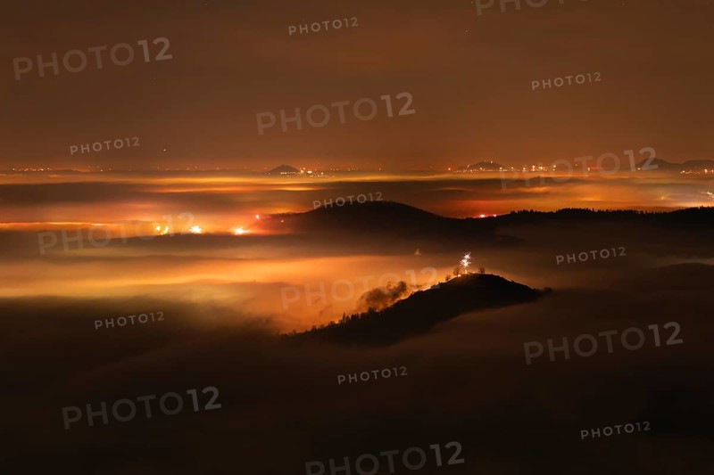 New Year's Eve fireworks 2024 on the Breitenstein, Swabian Alb near Ochsenwang. Sea of fog in the foothills of the Alb. View of the Drei Kaiserberge near Göppingen. In the foreground the Limburg and the Aichelberg