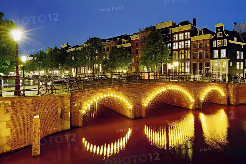 Seven bridges illuminated with neon lights at the corner of Keizersgracht and Reguliersgracht, Amsterdam, North Holland, Netherlands