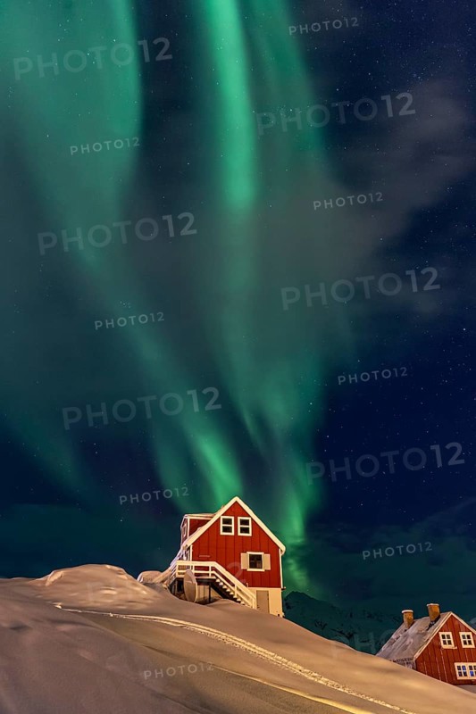 Northern Lights, Aurora borealis over red house, Inuit settlement, Winter, Tasiilaq, East Greenland, Greenland, North America