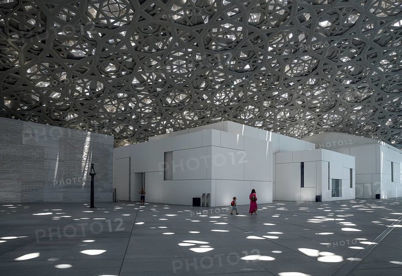 Visitors in the light rain of the Louvre Abu Dhabi, architect Jean Nouvel, Saadiyat Island, Abu Dhabi, United Arab Emirates, Asia