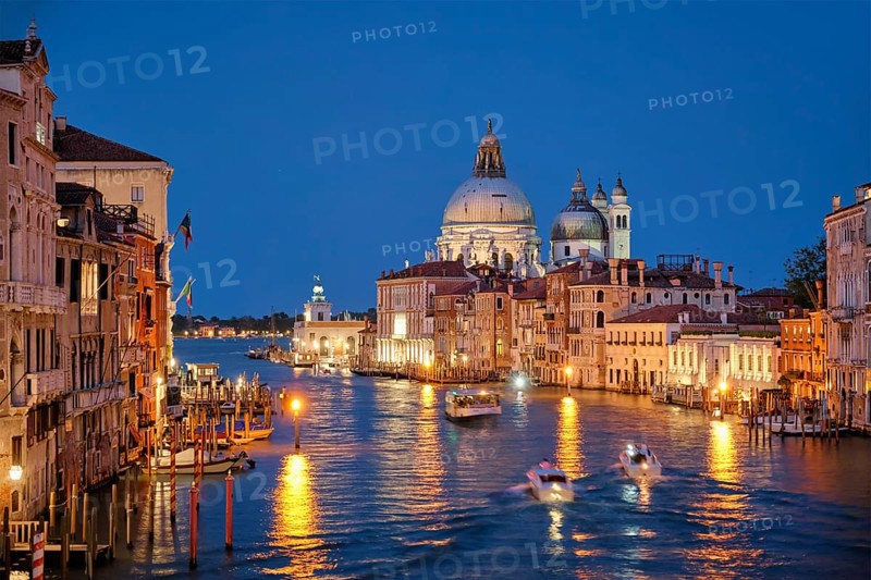 View of Venice Grand Canal with boats and Santa Maria della Salute church in the evening from Ponte dell'Accademia bridge. Venice, Italy, Europe