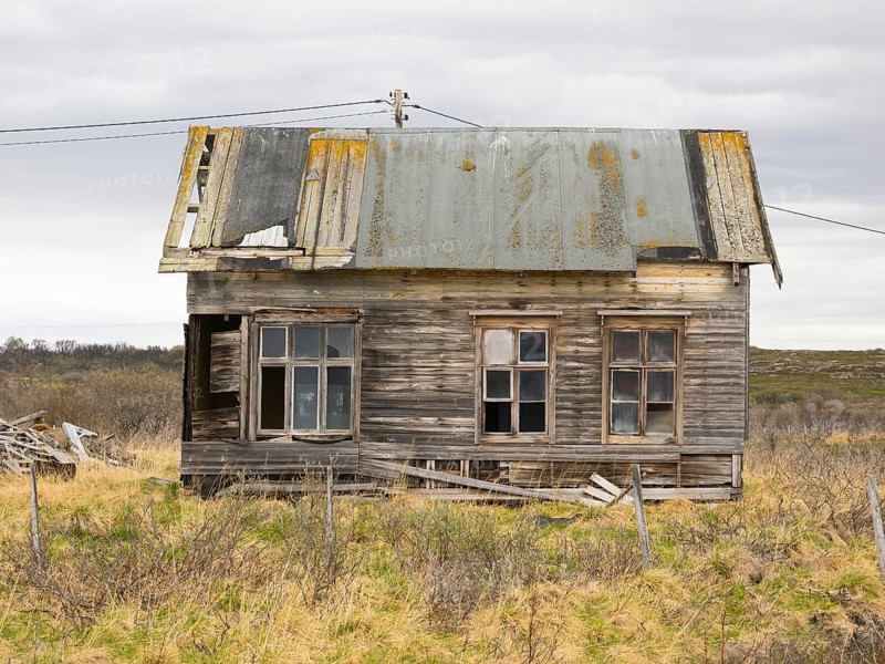 Derelict house on the shore of the Arctic Ocean, beside the town of Nesseby, May, Varangerfjord, Finnmark, Norway, Europe
