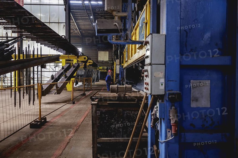 A worker stands at a boiler during a galvanising process. Taken during a press event at The Coatinc Company in Siegen, 22/08/2024